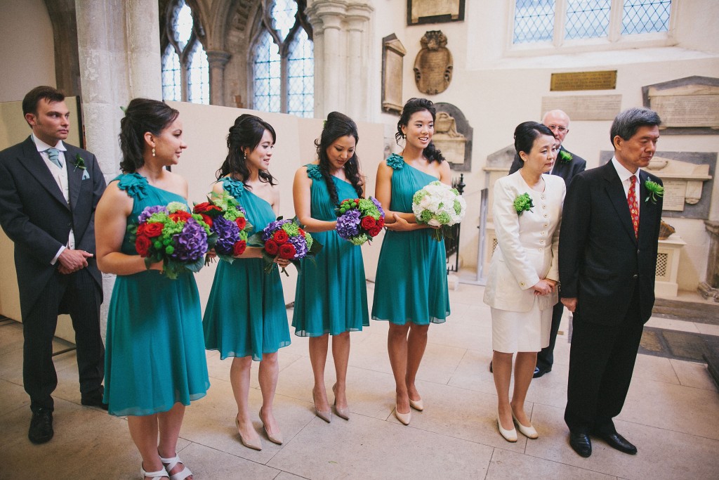 nicholau-nicholas-lau-interracial-wedding-bridesmaids-hold-colourful-bouquets-nude-heels-one-shoulder-teal-dresses