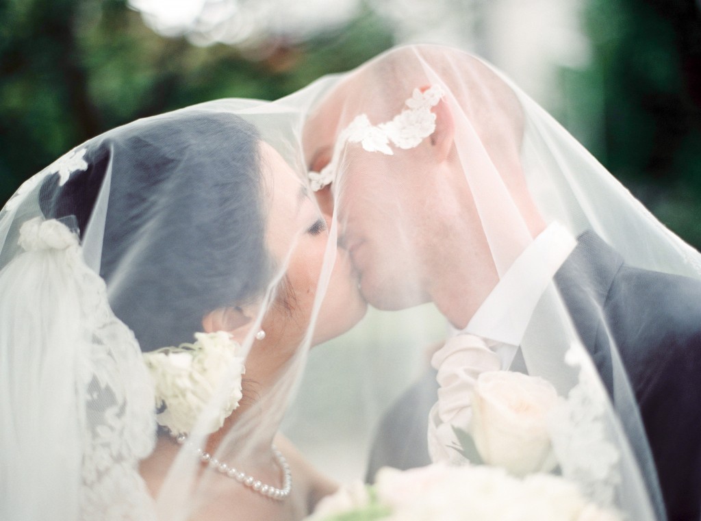 nicholau-nicholas-lau-interracial-wedding-kissing-bride-and-groom-under-a-veil-korean-white-caucasian