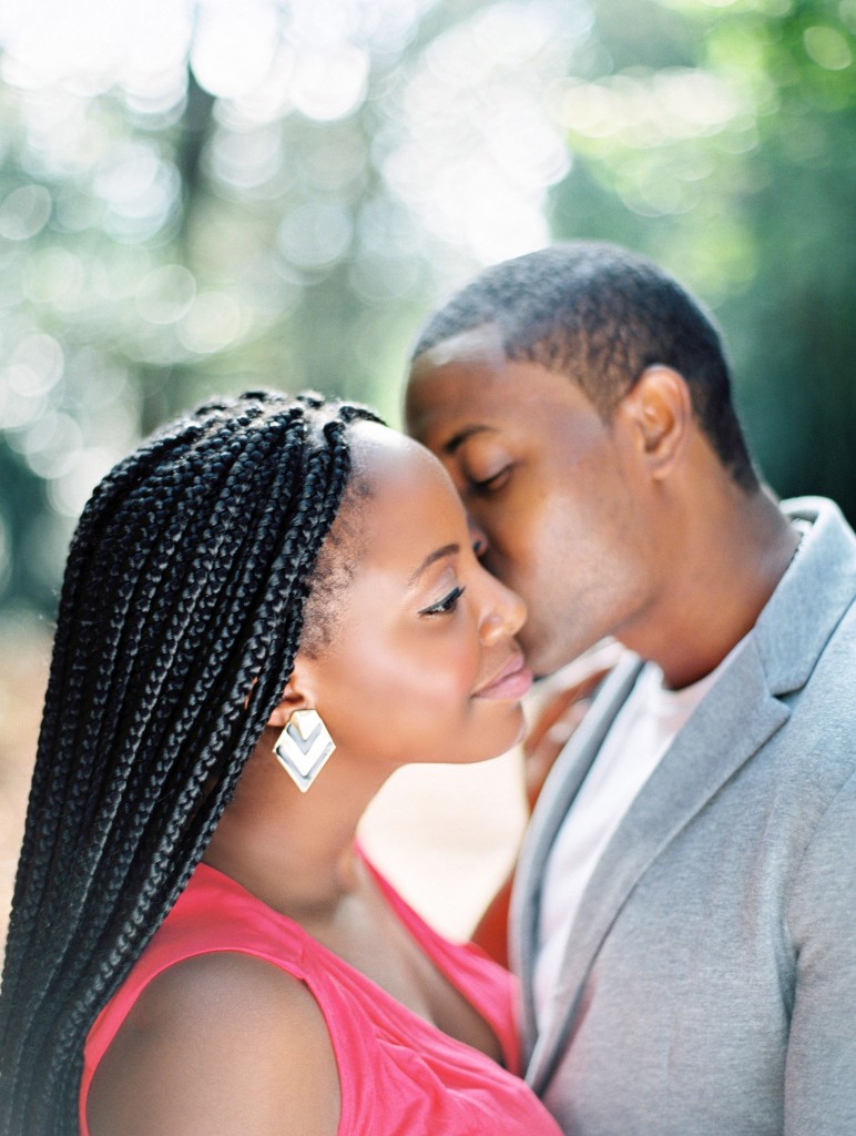 nicholau-nicholas-lau-photography-couples-session-pre-wedding-engagement-love-african-london-kiss-on-the-cheek-black-ebony-braids-outdoor-sun