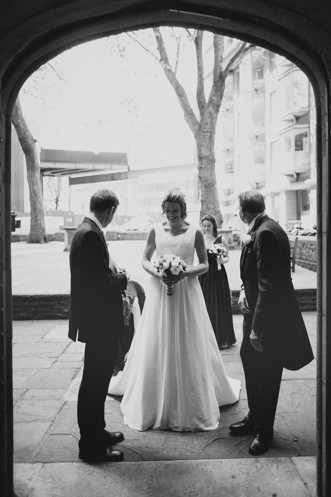 nicholas-lau-nicholau-london-weddings-fine-art-photography-leadenhall-market-st-helens-church-documentary-style-black-white-bride-enters