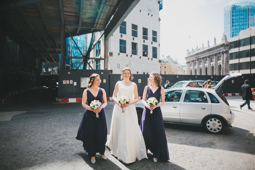 nicholas-lau-nicholau-london-weddings-fine-art-photography-leadenhall-market-st-helens-church-documentary-style-bride-with-her-hens-bridesmaids-walking-together-dresses-navy-white