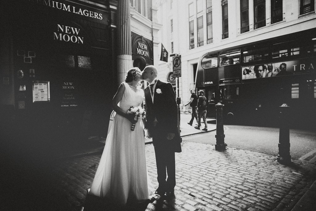 nicholas-lau-nicholau-london-weddings-fine-art-photography-leadenhall-market-st-helens-church-documentary-style-white-black-dress-groom-kiss-bride-doubledecker-bus