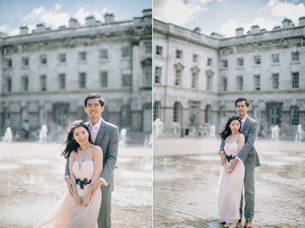 nicholas-lau-nicholau-chinese-london-uk-film-fine-art-photography-engagement-couple-pre-wedding-grey-suit-cute-romance-somerset-house-fountains-wind-hold-tight