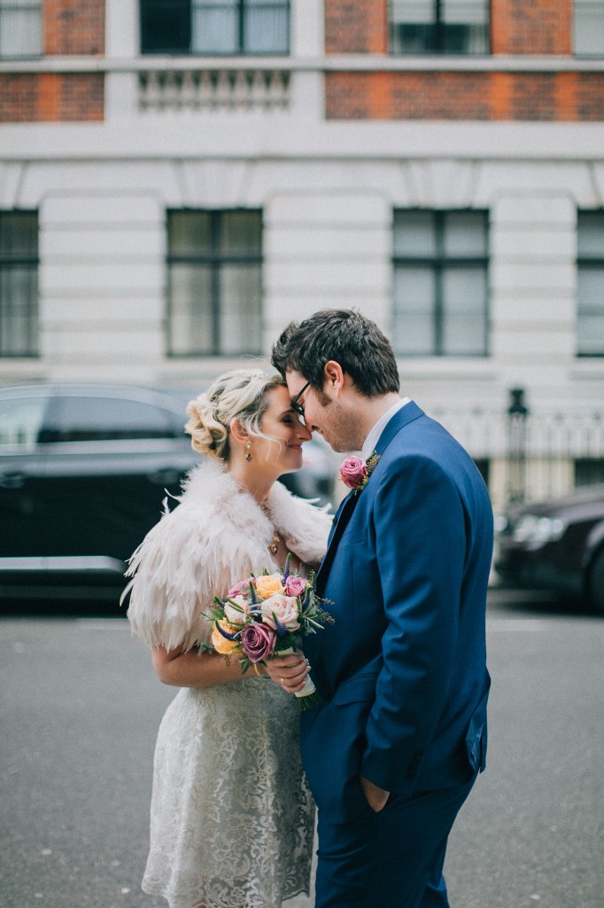 nicholas-lau-nicholau-wedding-photography-photographer-fine-art-film-winter-christmas-london-UK-modern-unique-the-arch-asia-house-forehead-nuzzles-kissing-kiss-bride-groom-blue-suit-white-dress