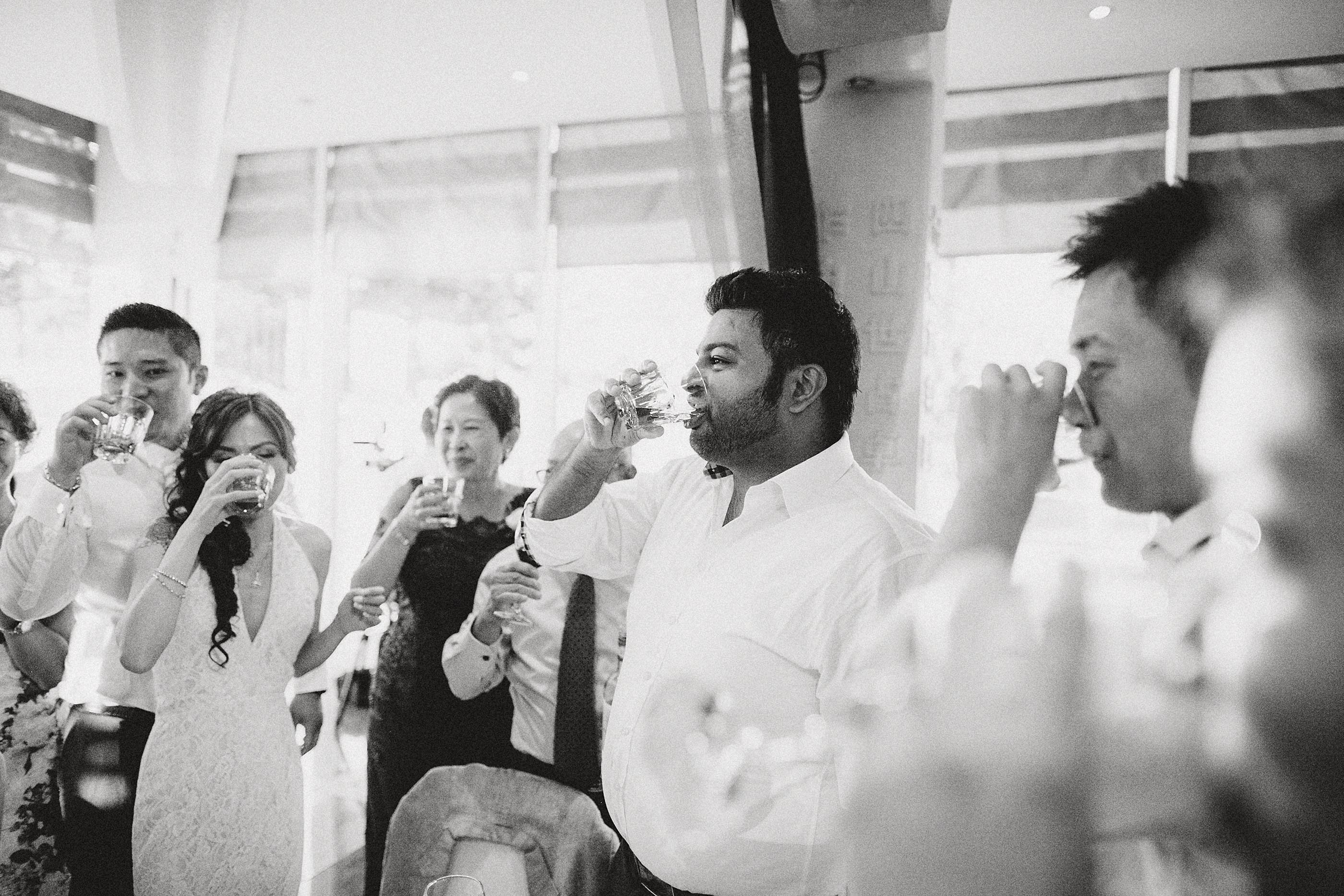 nicholas-lau-photo-photography-fine-art-film-wedding-london-asian-chinese-uk-mulitcultural-ceremony-reception-black-white-china-boulevard-guests-drinking-toasts